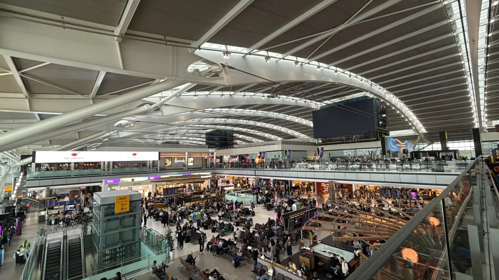 Passengers beneath the sweeping roof of London Heathrow Terminal 5 in October 2025