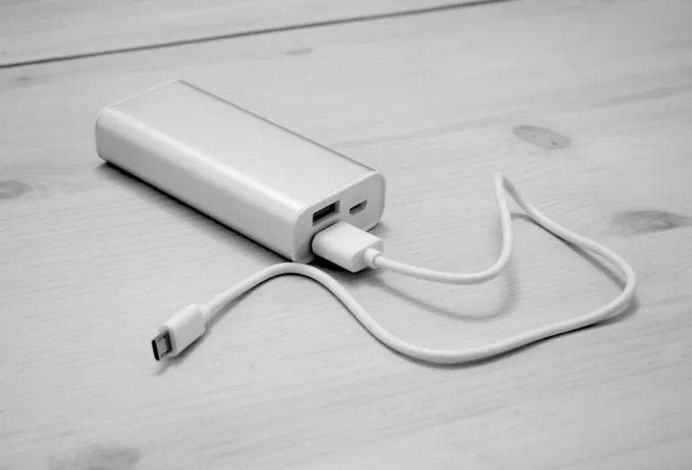Portable power bank with a USB charging cable on a table, archive photograph
